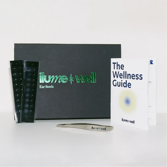 ilumewell product set with ear seeds, tweezers, and wellness guide on a white background