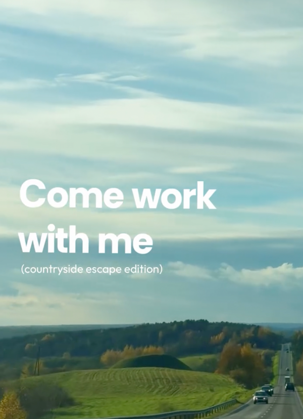 Scenic road with green fields and trees under a blue sky, with text 'Come work with me (countryside escape edition)'